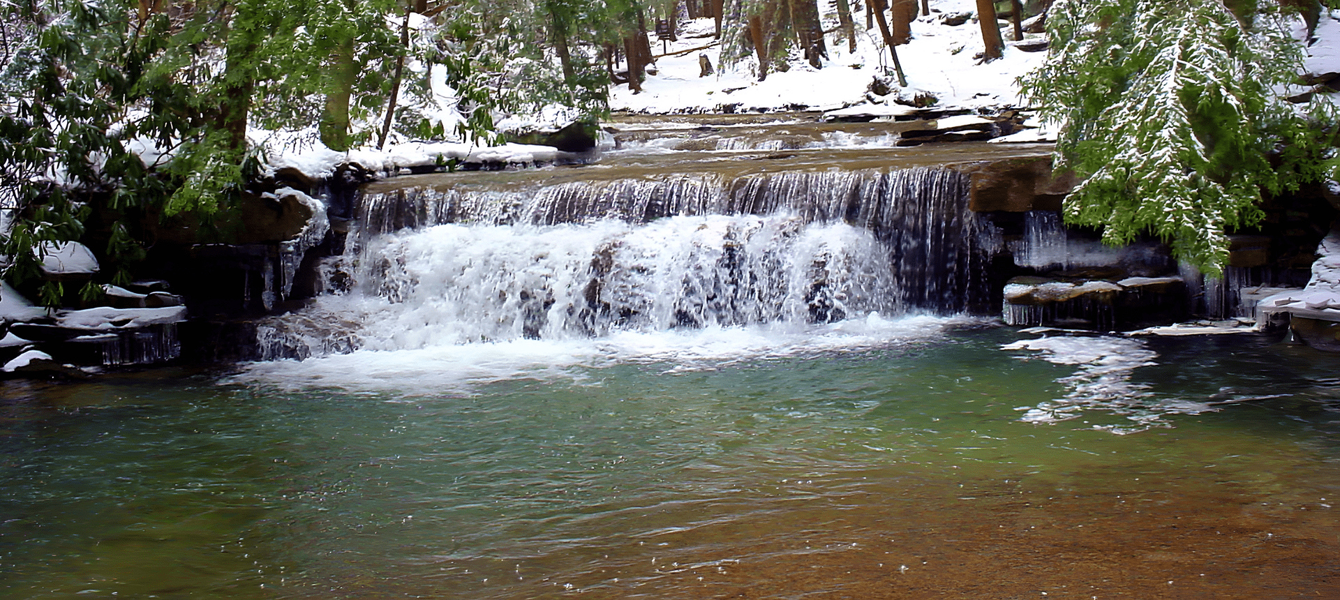 Snowy waterfall in a forest setting